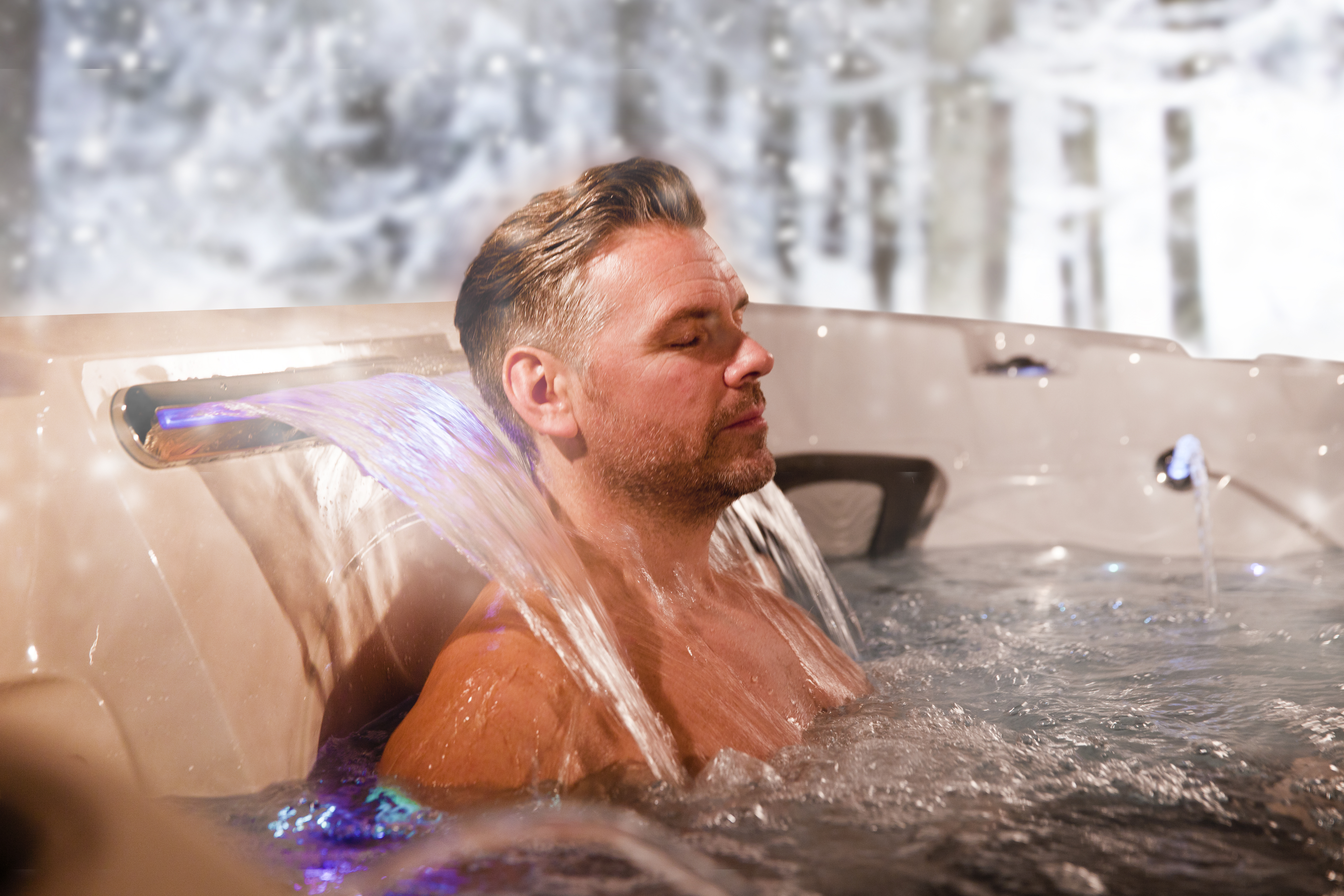 Coast Spas relaxing under waterfall